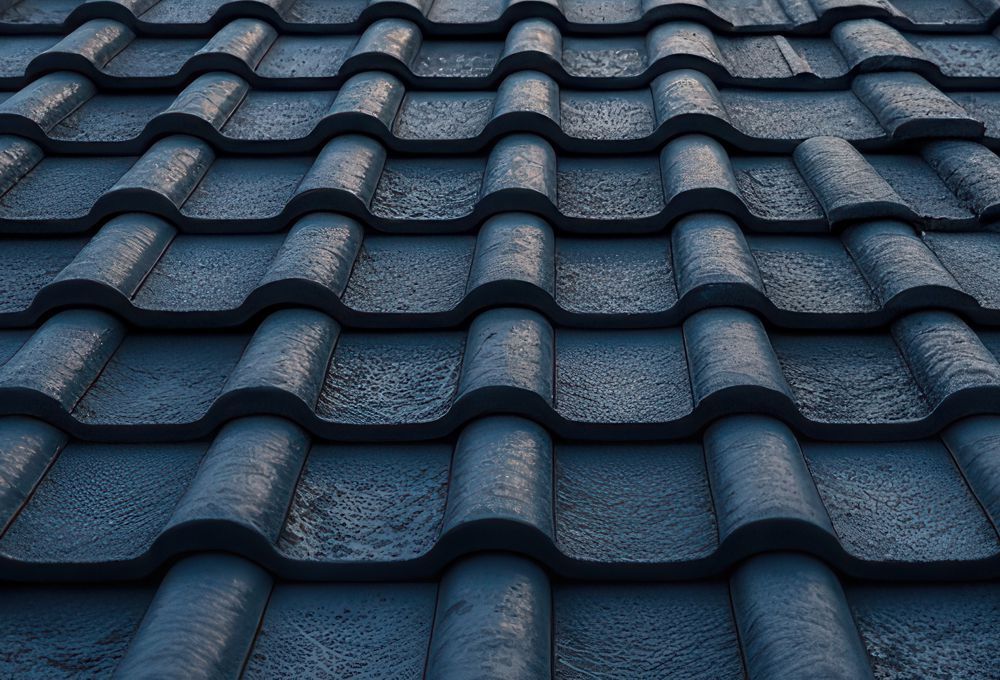 Close-up of blue-gray wavy roof tiles with a textured, repeating pattern