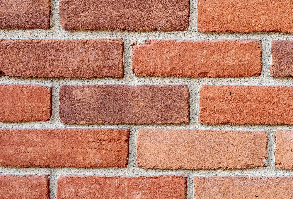 Red brick wall with light gray mortar lines