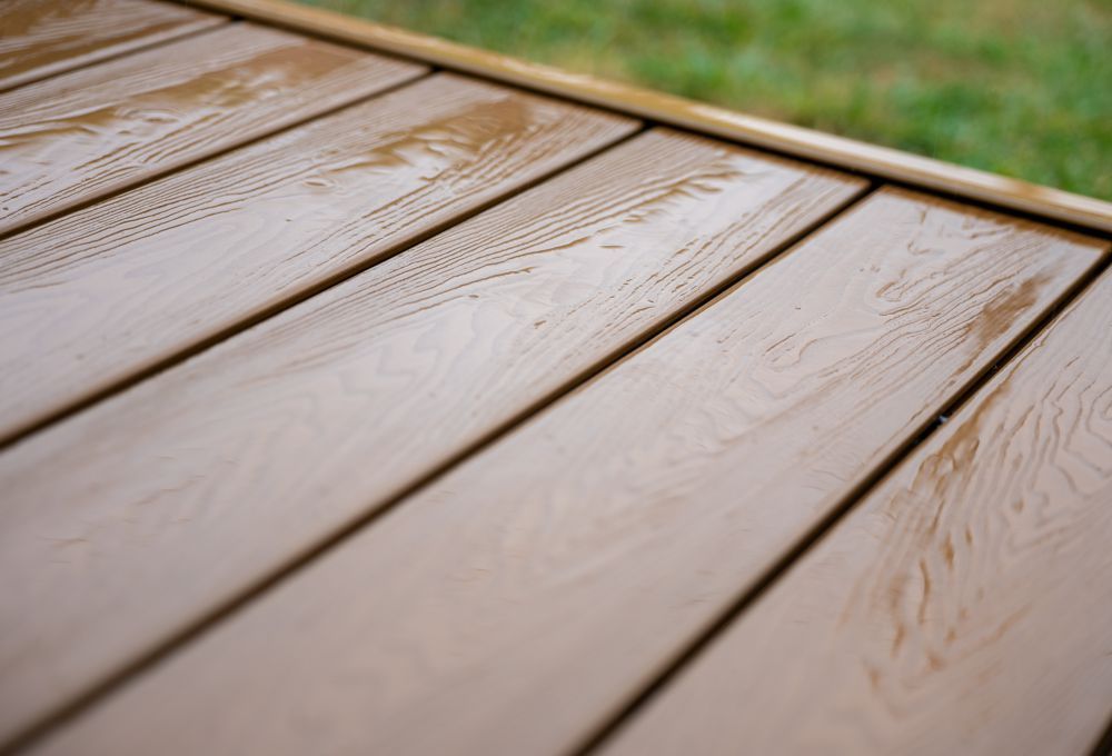 Close-up of light brown wooden deck boards with visible grain and diagonal planks
