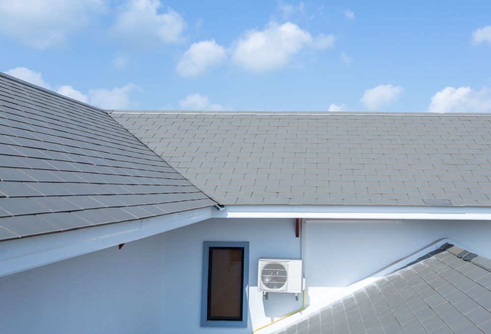 White house roof and skylights under a blue sky
