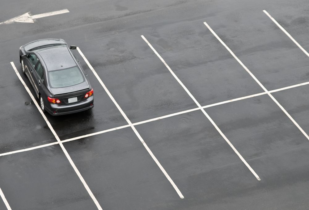 Silver SUV parked in an empty marked parking lot