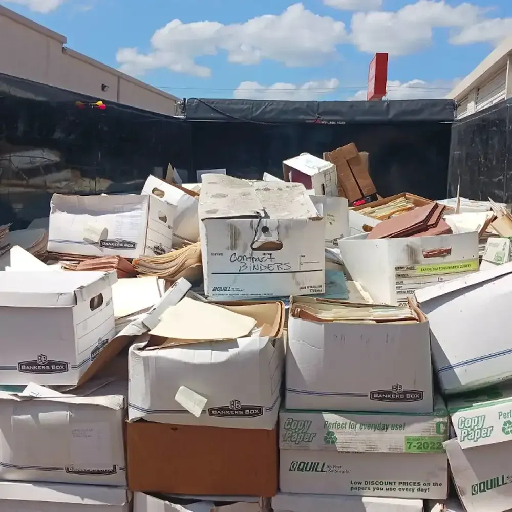 truck filled with stacked cardboard boxes and packing boxes under a blue sky