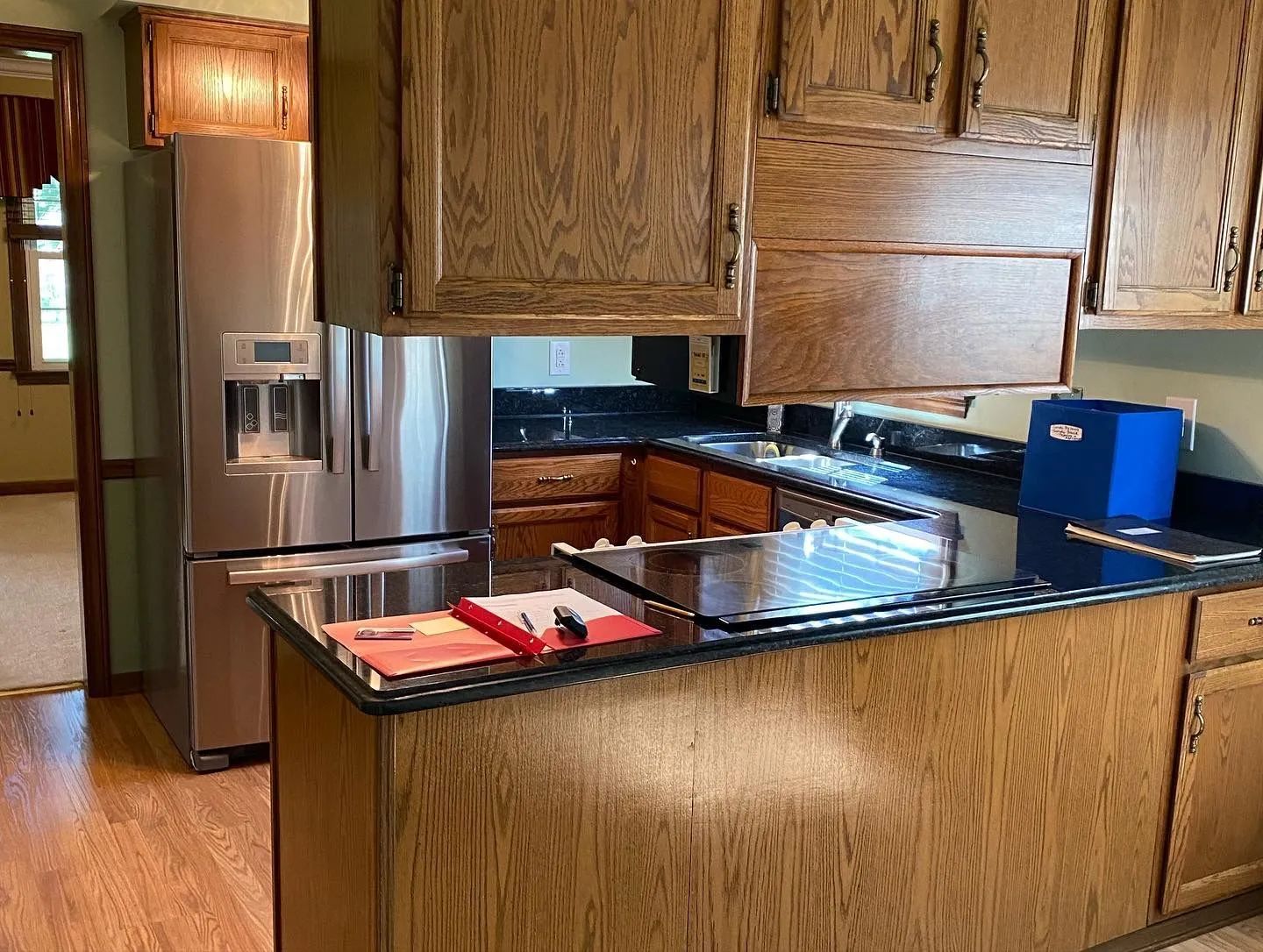A kitchen with stainless steel appliances and wooden cabinets