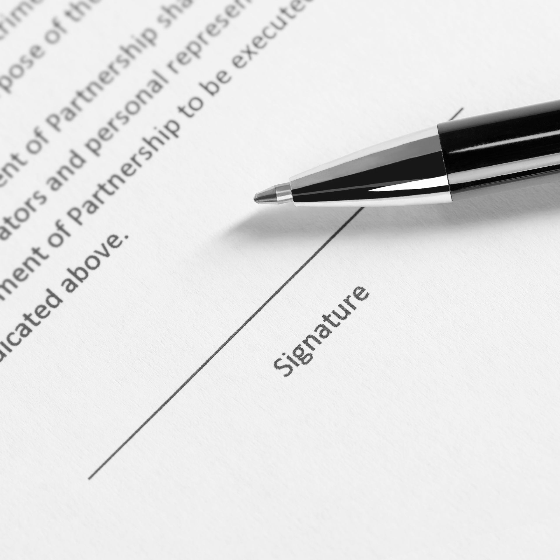 A black pen rests on a document line labeled