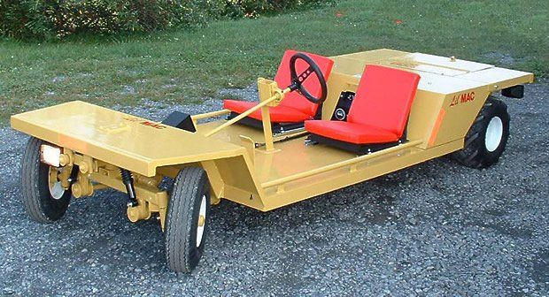 Yellow flatbed cart with red seats and a black steering wheel. Outdoor setting.