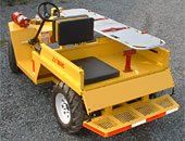 Yellow emergency cart with a stretcher, fire extinguisher, and off-road tires.