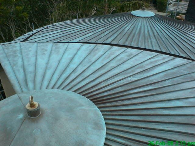 Round Roofs in Double Standing Seam with Tapered Panels with Custom Patina Applied