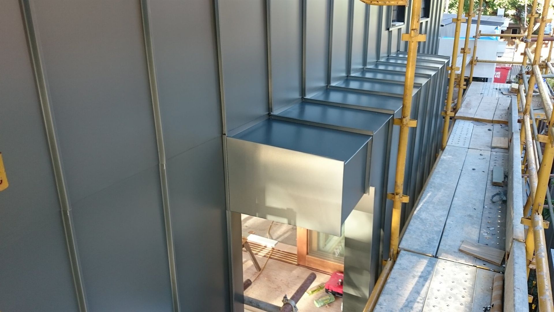 Wall Cladding in Angle Standing Seam System in Brushed Gun Metal Aluminium