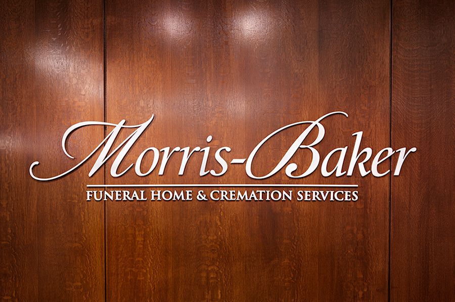 Morris-Baker funeral home and cremation services sign on a wooden wall Johnson City, TN.