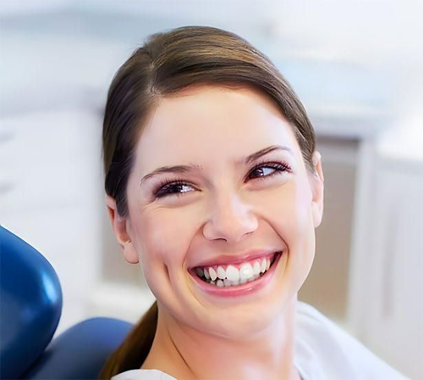 A Woman is Flossing Her Teeth With a Dental Floss — Advanced Dental Southern Highlands in Moss Vale, NSW