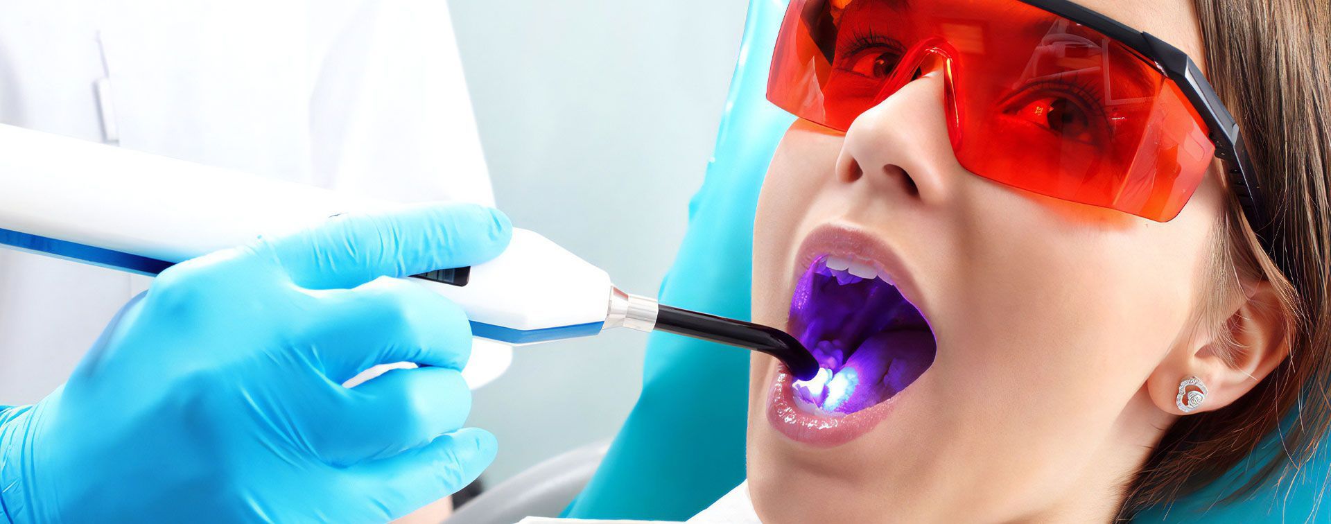 A Woman is Getting Her Teeth Whitened by a Dentist — Advanced Dental Southern Highlands in Moss Vale, NSW