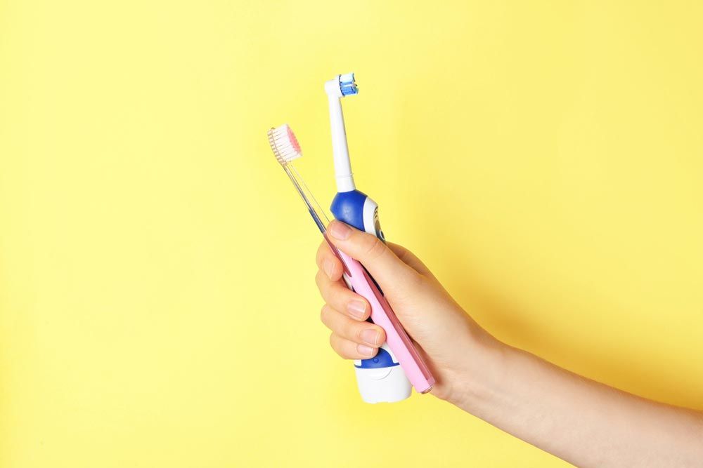 Holding Different Toothbrushes