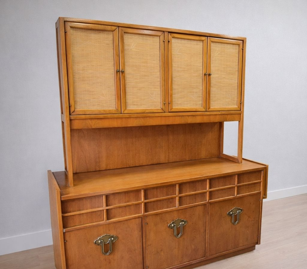 Wooden hutch with upper cabinets, open shelf, and lower drawers on a white wall.