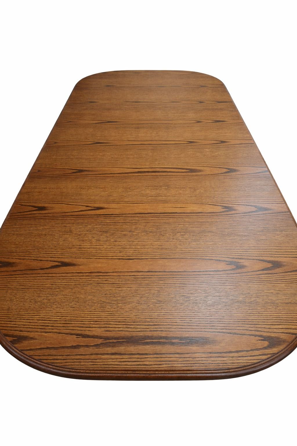 Wooden tabletop with rounded front edge and tapered shape on a white background
