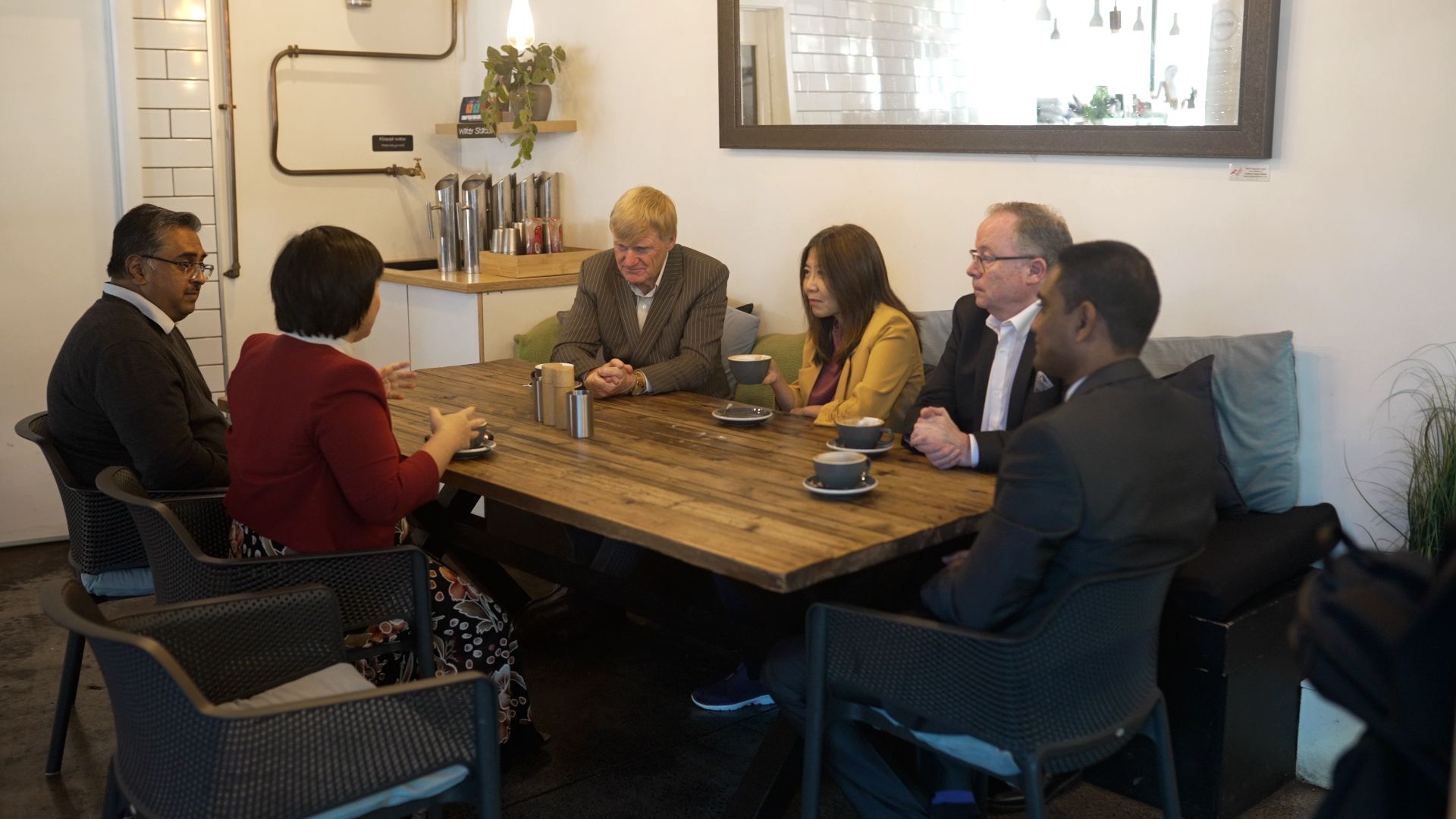 People sitting around a cafe table