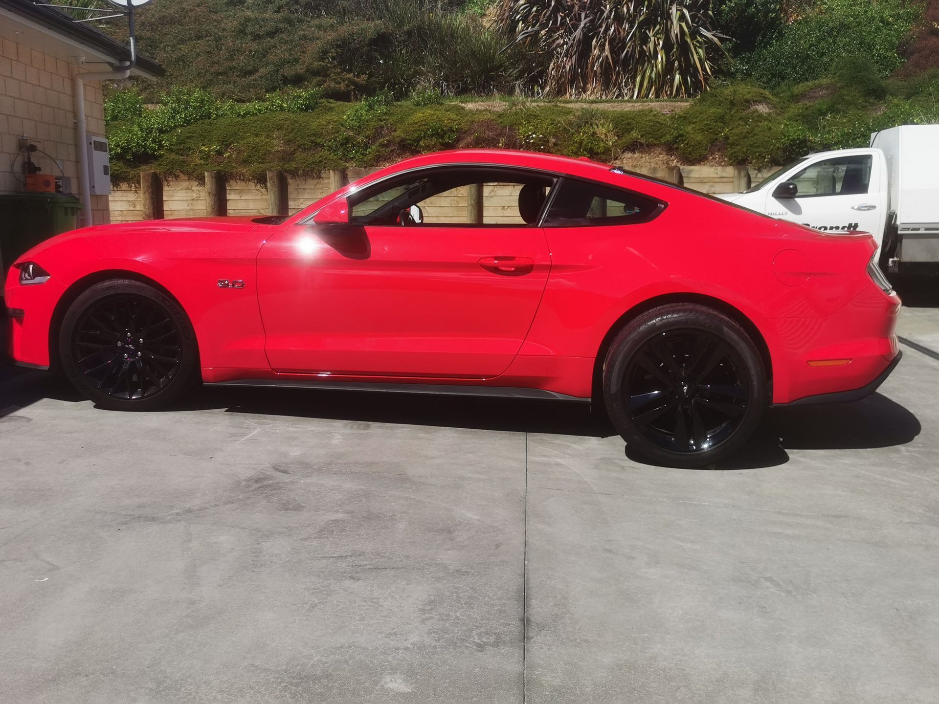 A red car parked in a driveway