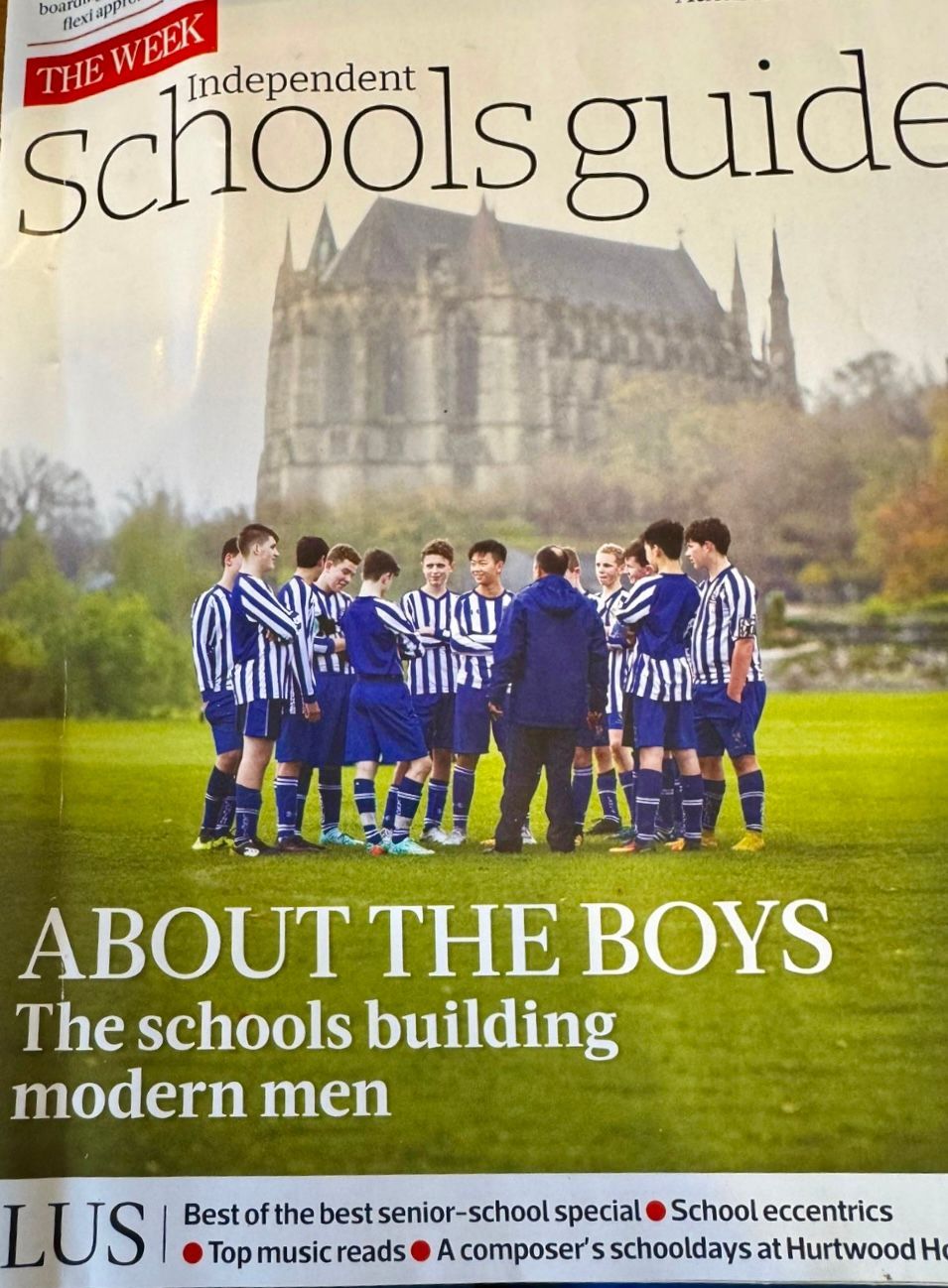 School guide cover with boys in blue uniforms standing on grass before a large school building and cathedral-like backdrop