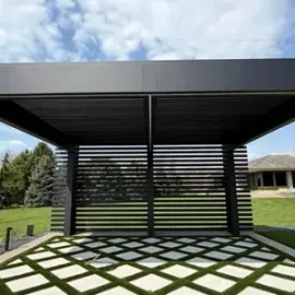 Modern black pergola with slatted walls over a patterned stone patio in a landscaped yard