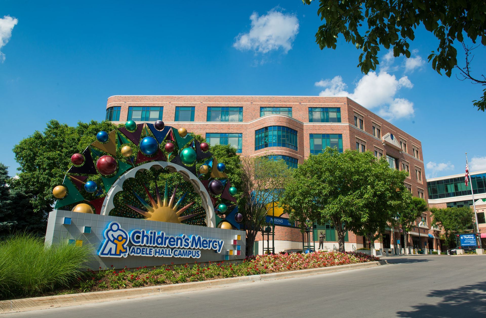 Children’s Medical Center entrance with holiday wreaths and colorful ornaments under a blue sky