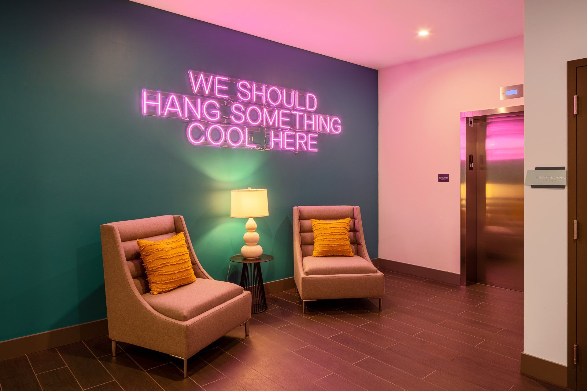 Aspire Apartment Complex Lounge With Neon Sign Reading