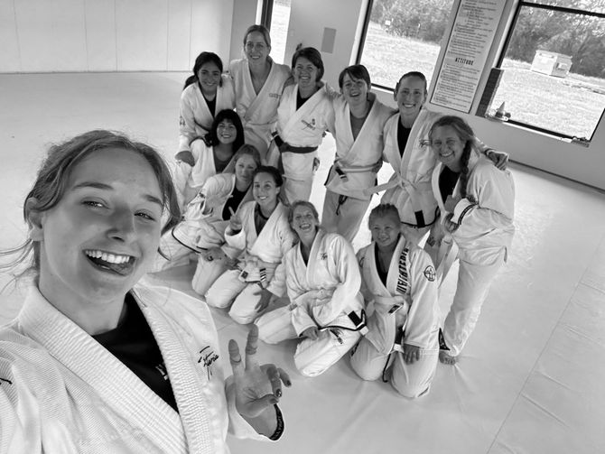 A group of women are posing for a picture in a gym.