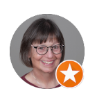 Portrait of a smiling person with short dark hair and glasses, with an orange star badge overlay