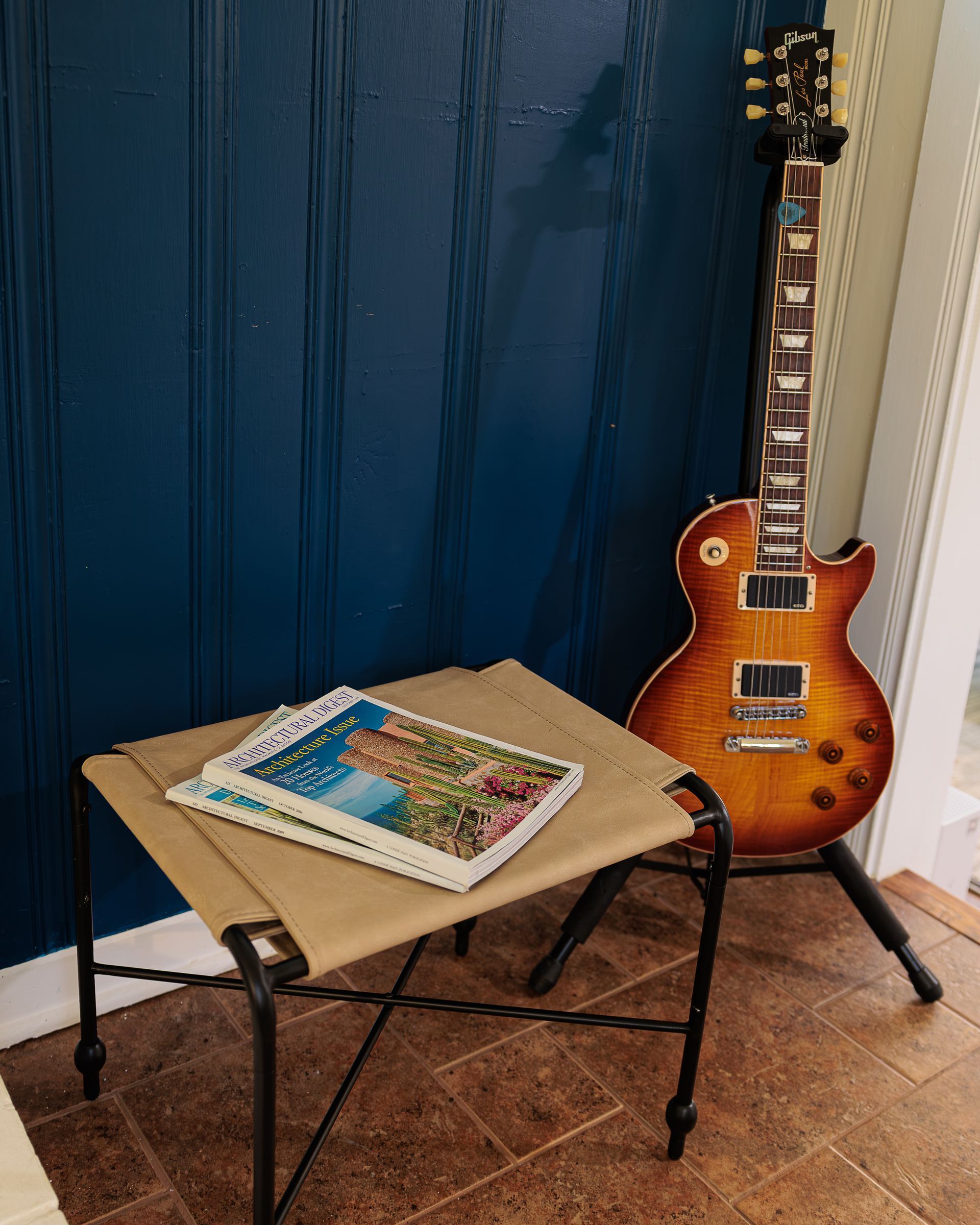 Deep blue accent wall with guitar and dark wood trim