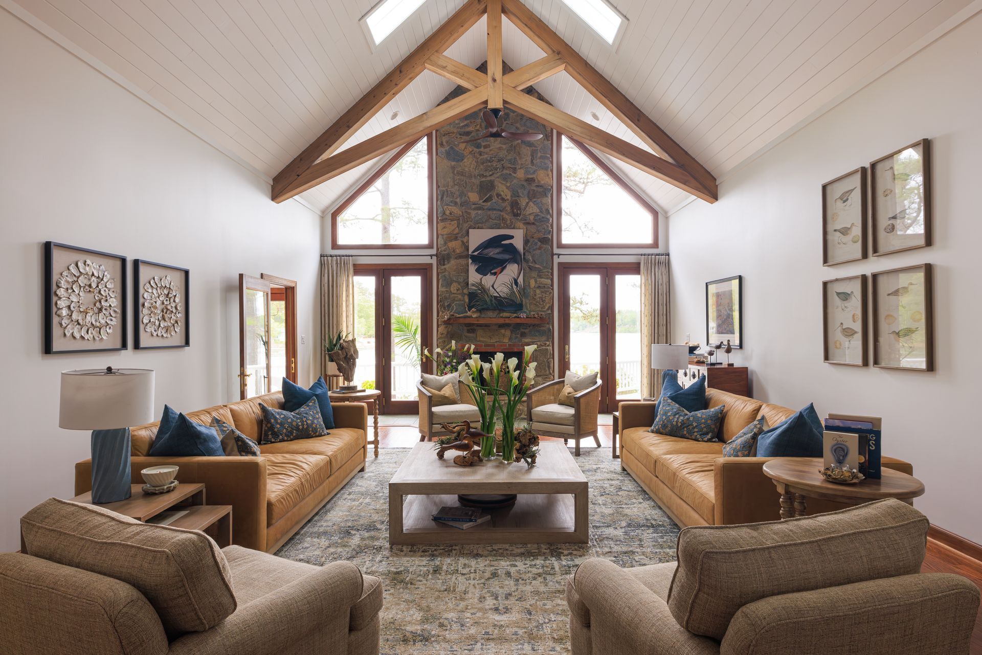 Coastal-inspired living room with warm wood beams and stone fireplace