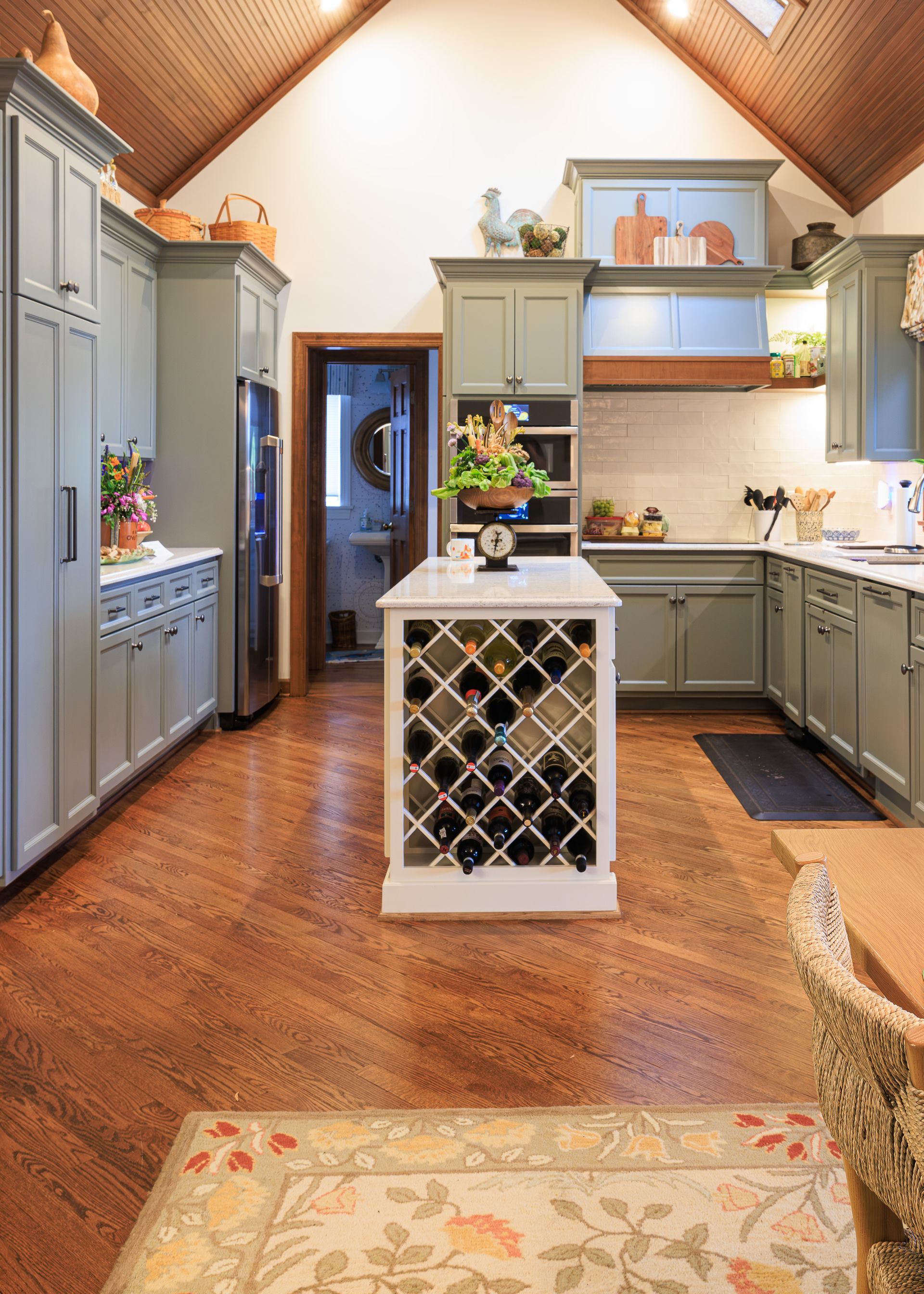 Custom kitchen with painted cabinetry, natural wood accents, and recessed lighting