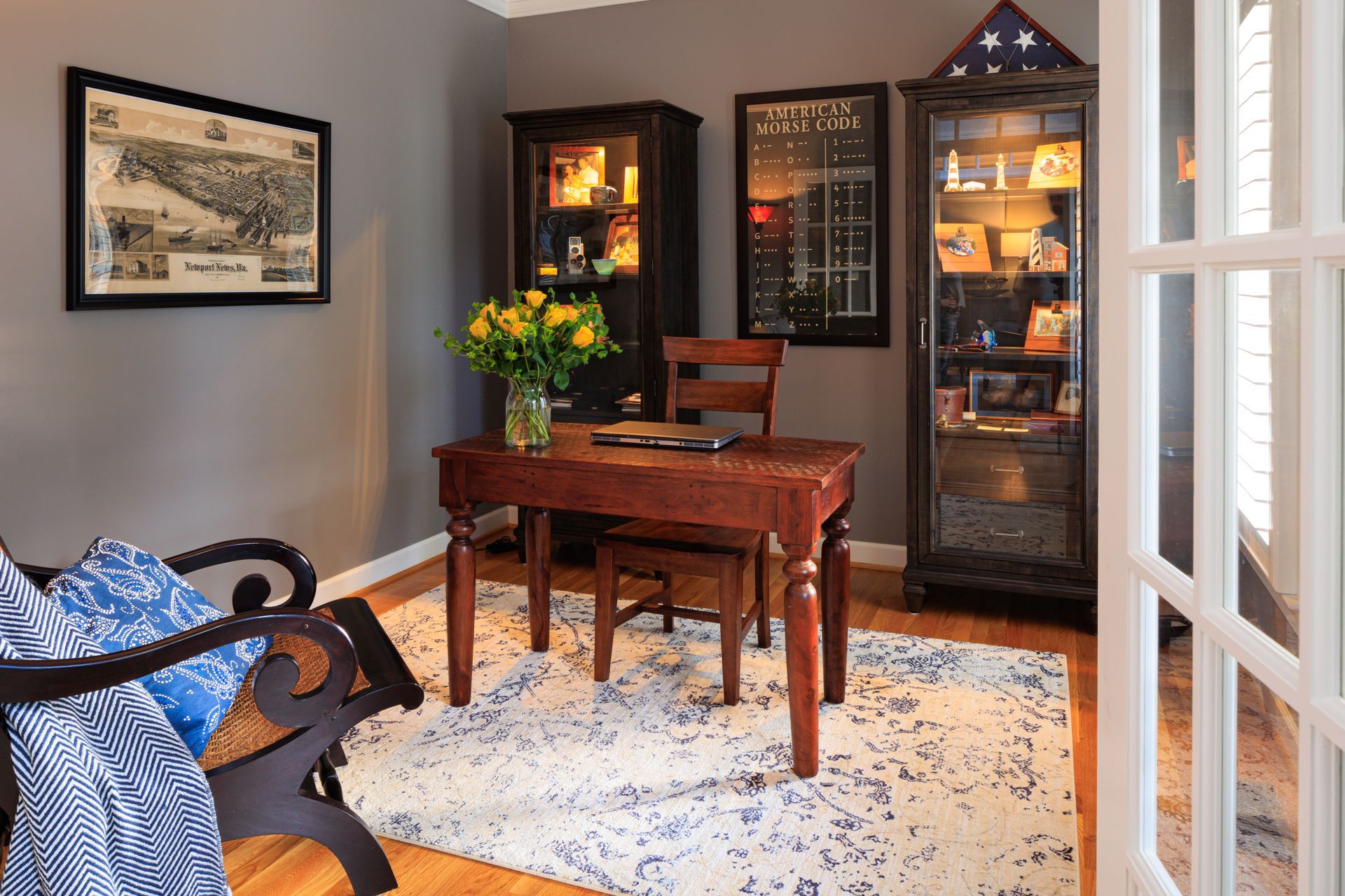 After redesign: styled office spacewith warm wood furniture, display cabinets, and layered decor