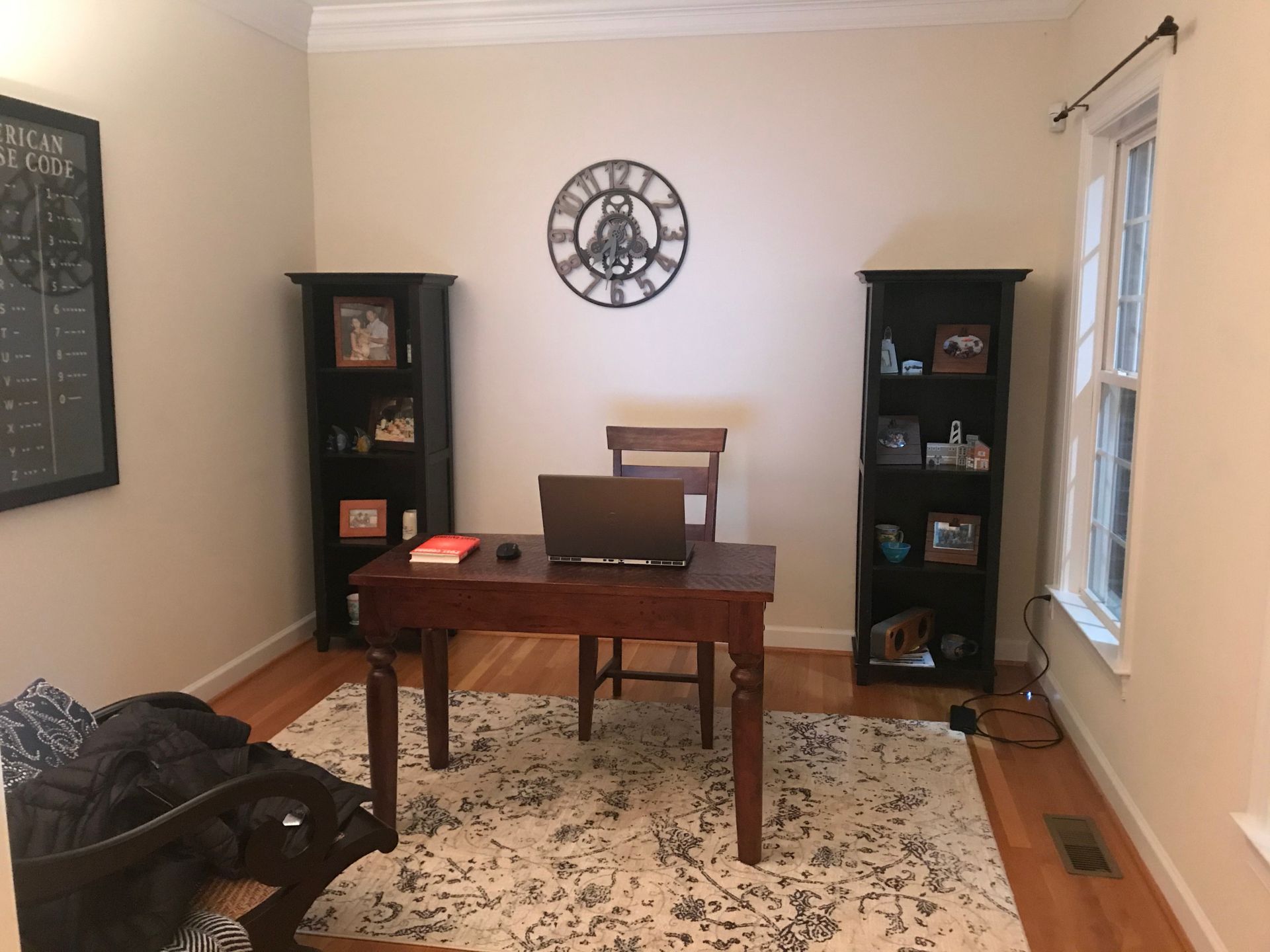 Before redesign: office space with dark display cabinets and minimal furnishings