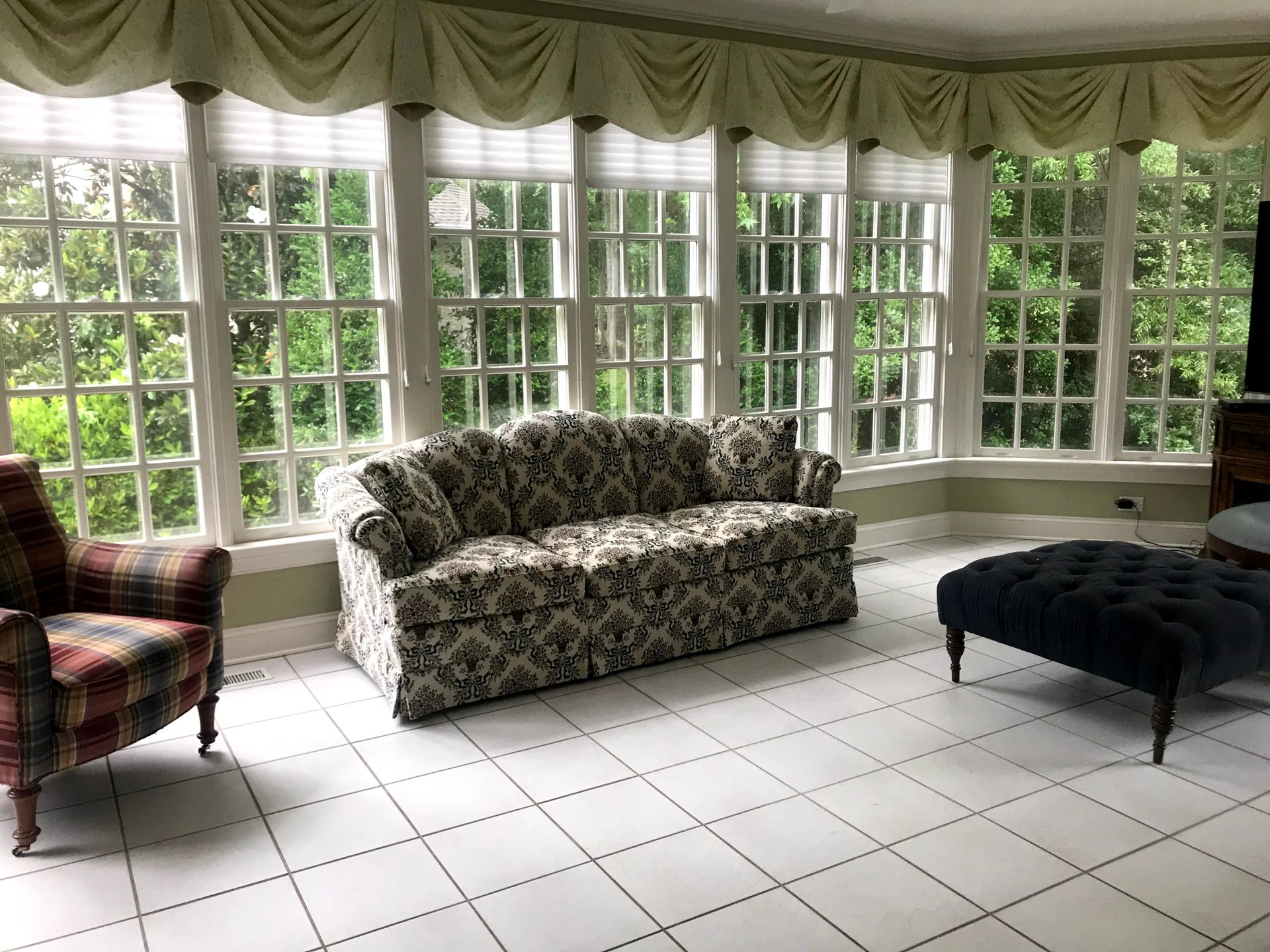 Sunroom with bay windows, valance treatment, and patterned seating