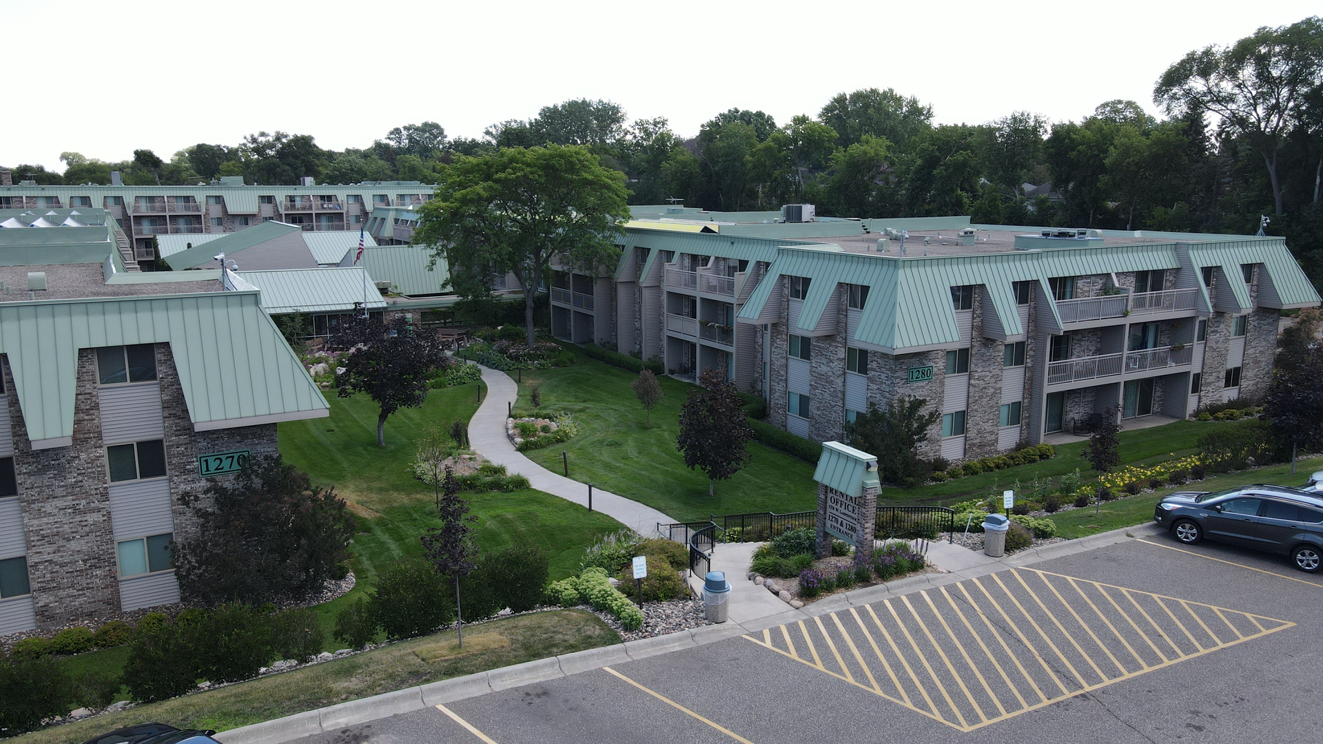 an aerial view of a large apartment building with green roofs
