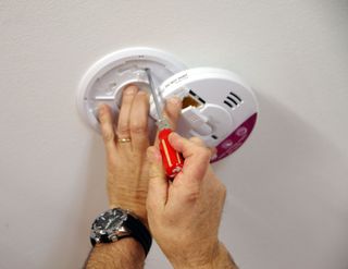 Electrician installing a smoke and CO alarm, Sonoma, CA