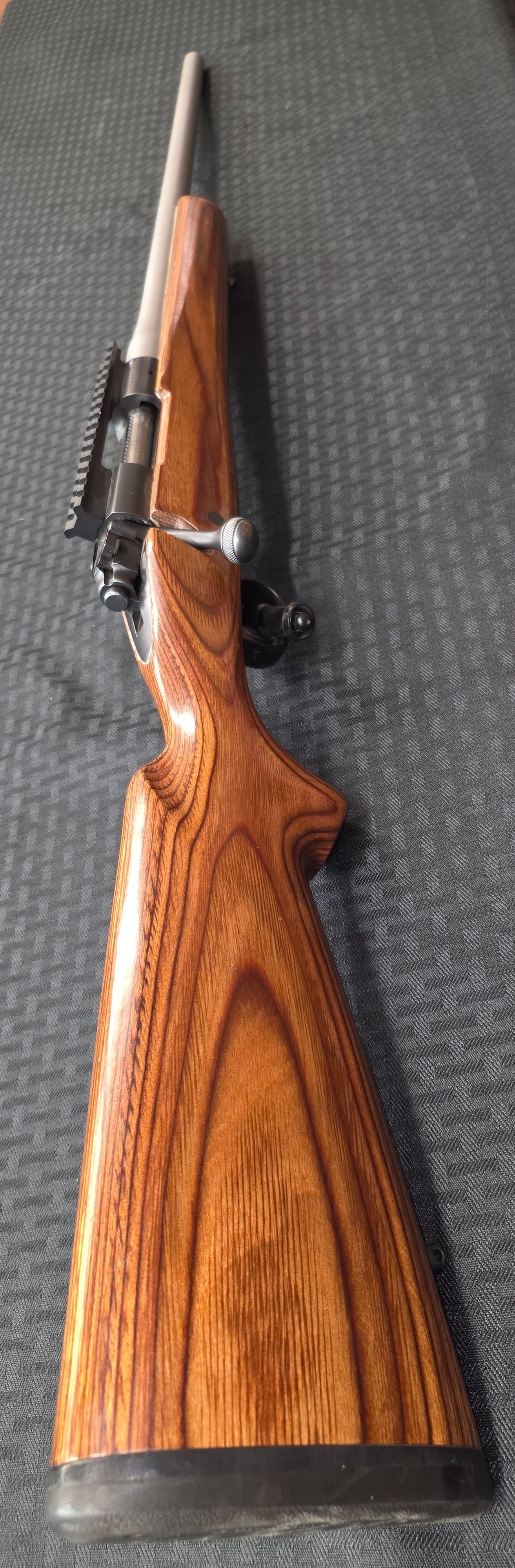 A silver-toned semi-automatic pistol engraved with 