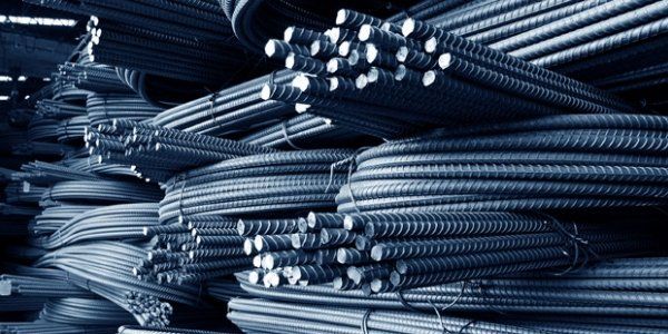 a pile of steel bars stacked on top of each other .