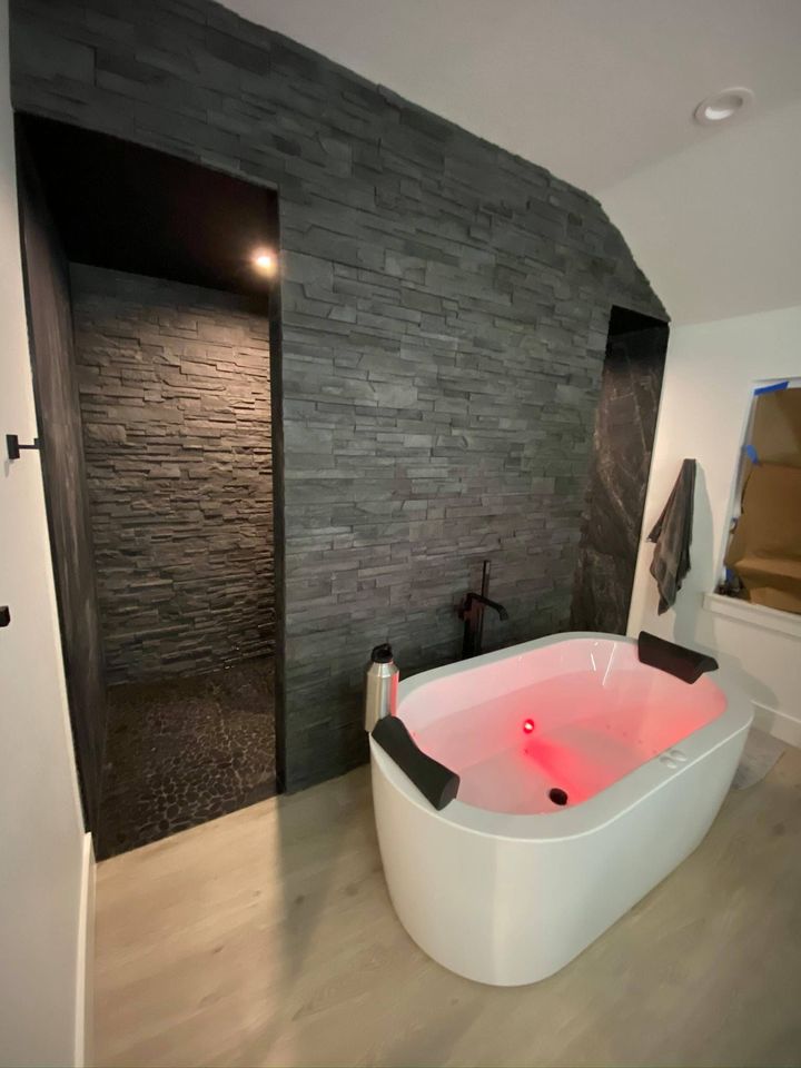 a bathroom with a bathtub and a walk in shower .
