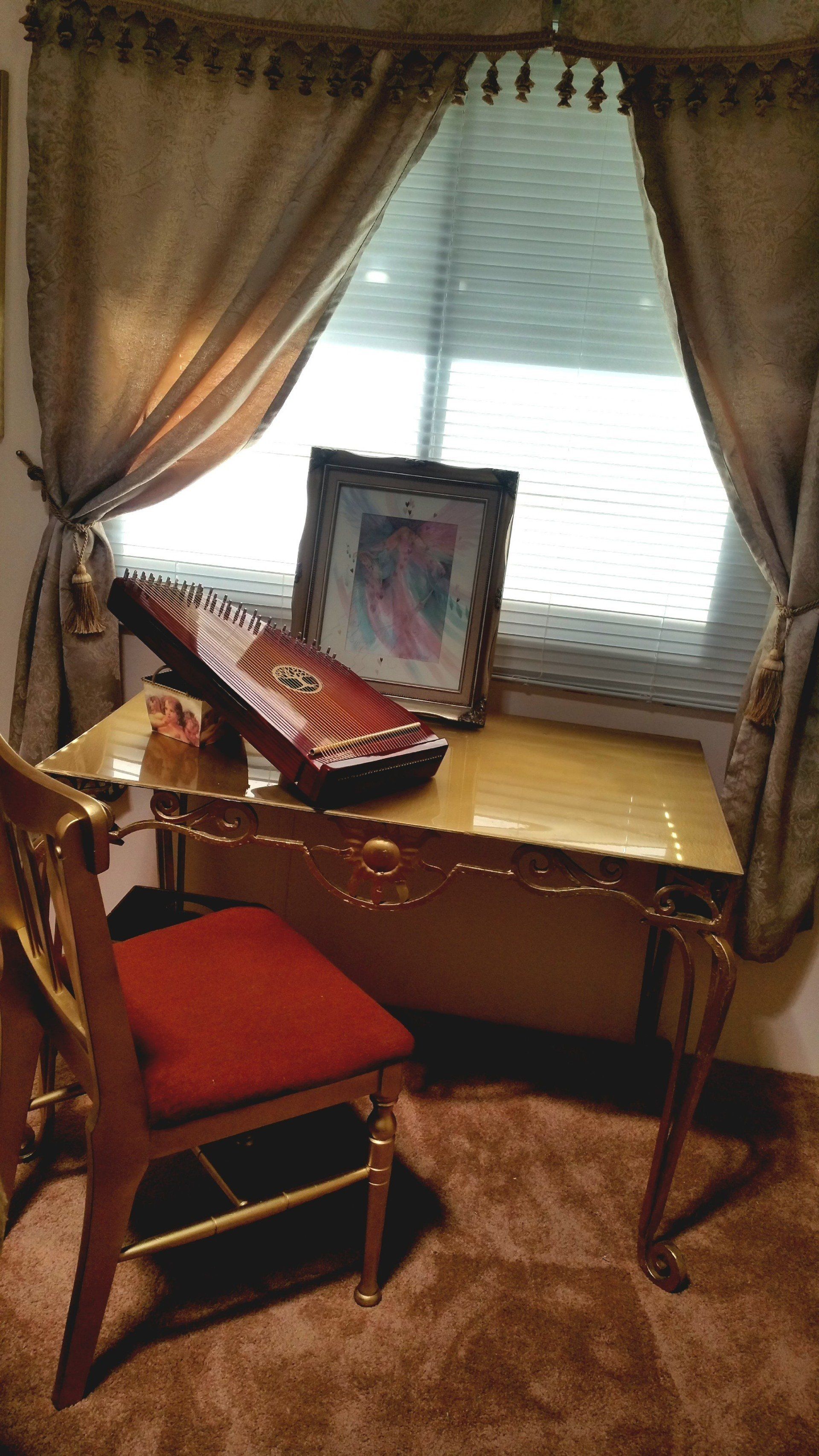 A room with a desk and chair in front of a window