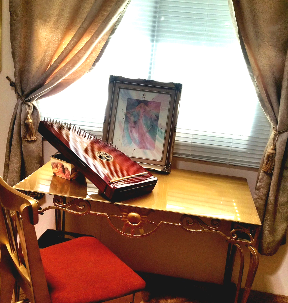 A harp sits on a table in front of a window