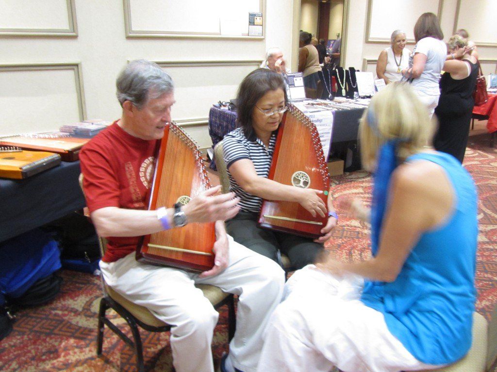 A group of people are playing harps in a room