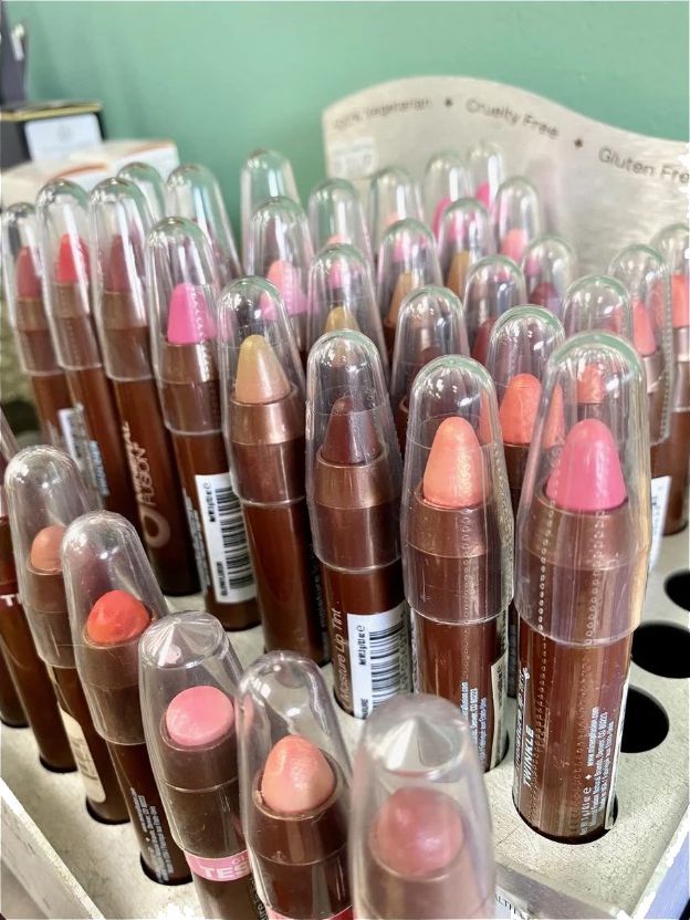 A bunch of lipsticks are sitting in a display case