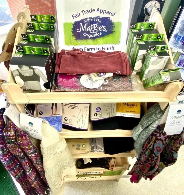 A Shelf With a Sign That Says Fair Trade Apparel