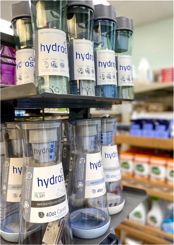 A Bunch of Water Bottles Are Sitting on a Shelf in a Store