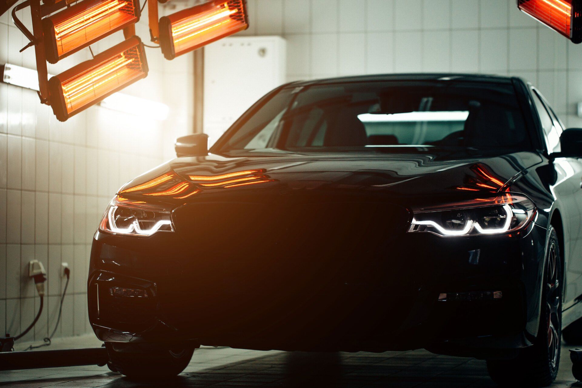 Car under infrared lights for faster paint drying