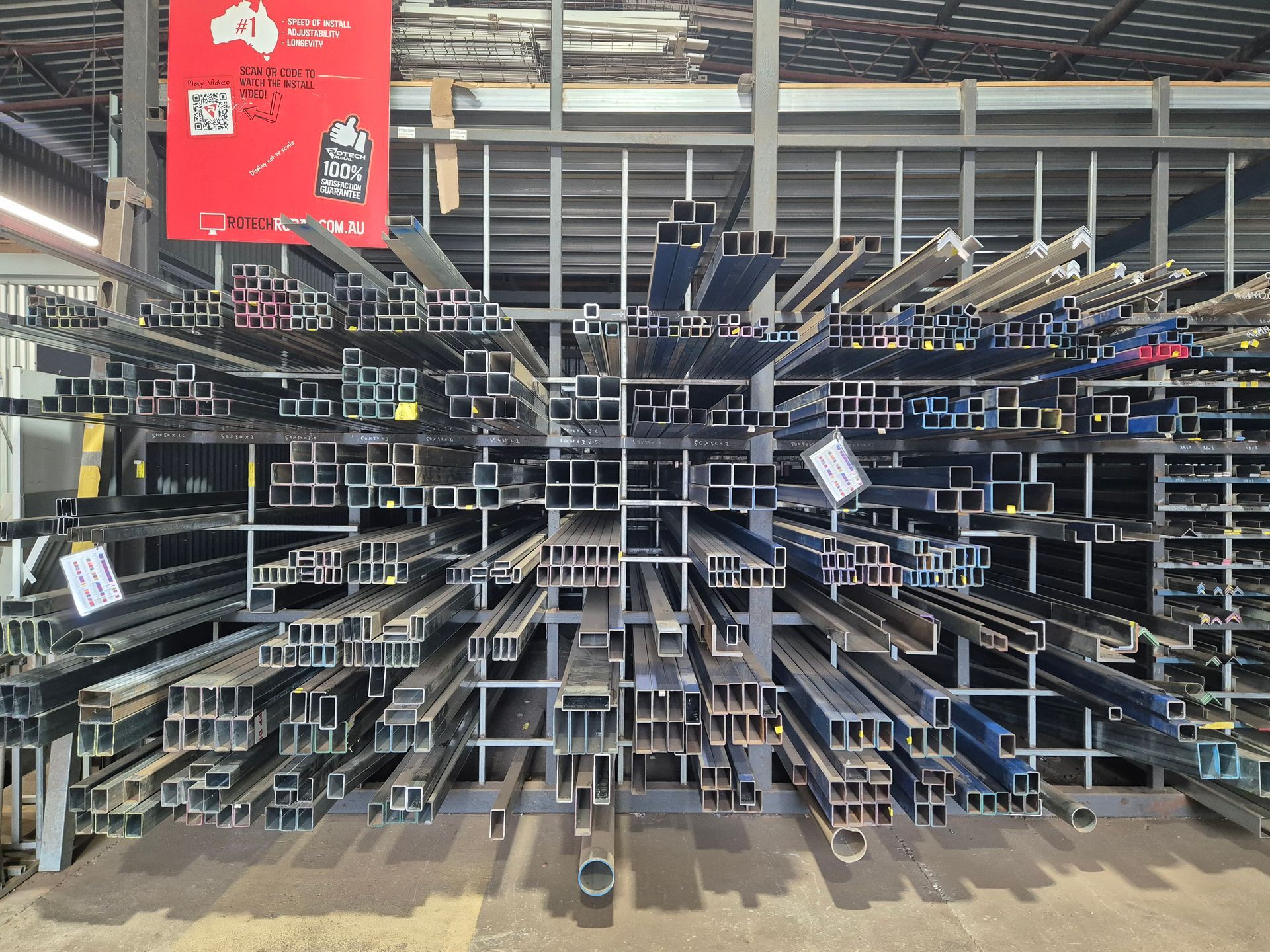 Metal beams organized on shelves in a warehouse.