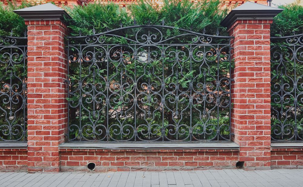 Red Brick Pillars Supporting an Ornate Black Iron Fence — Western Pacific Steel in South Grafton, NSW
