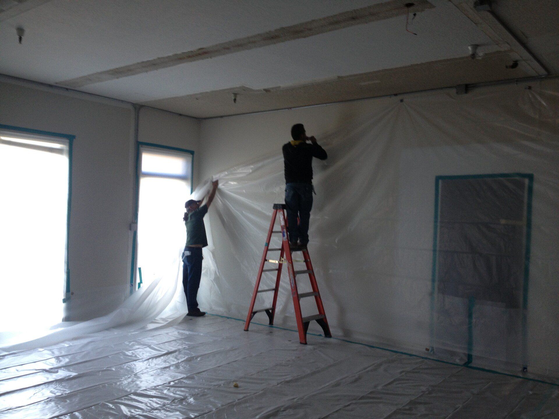 Two Men Fixing Wall Inside House — Campbell, CA — JWH Asbestos Removal Services