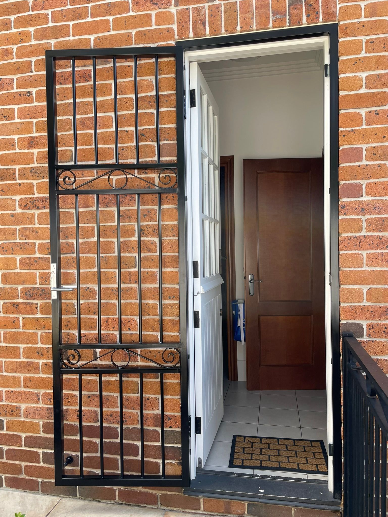 A set of stairs leading up to a house with a railing.