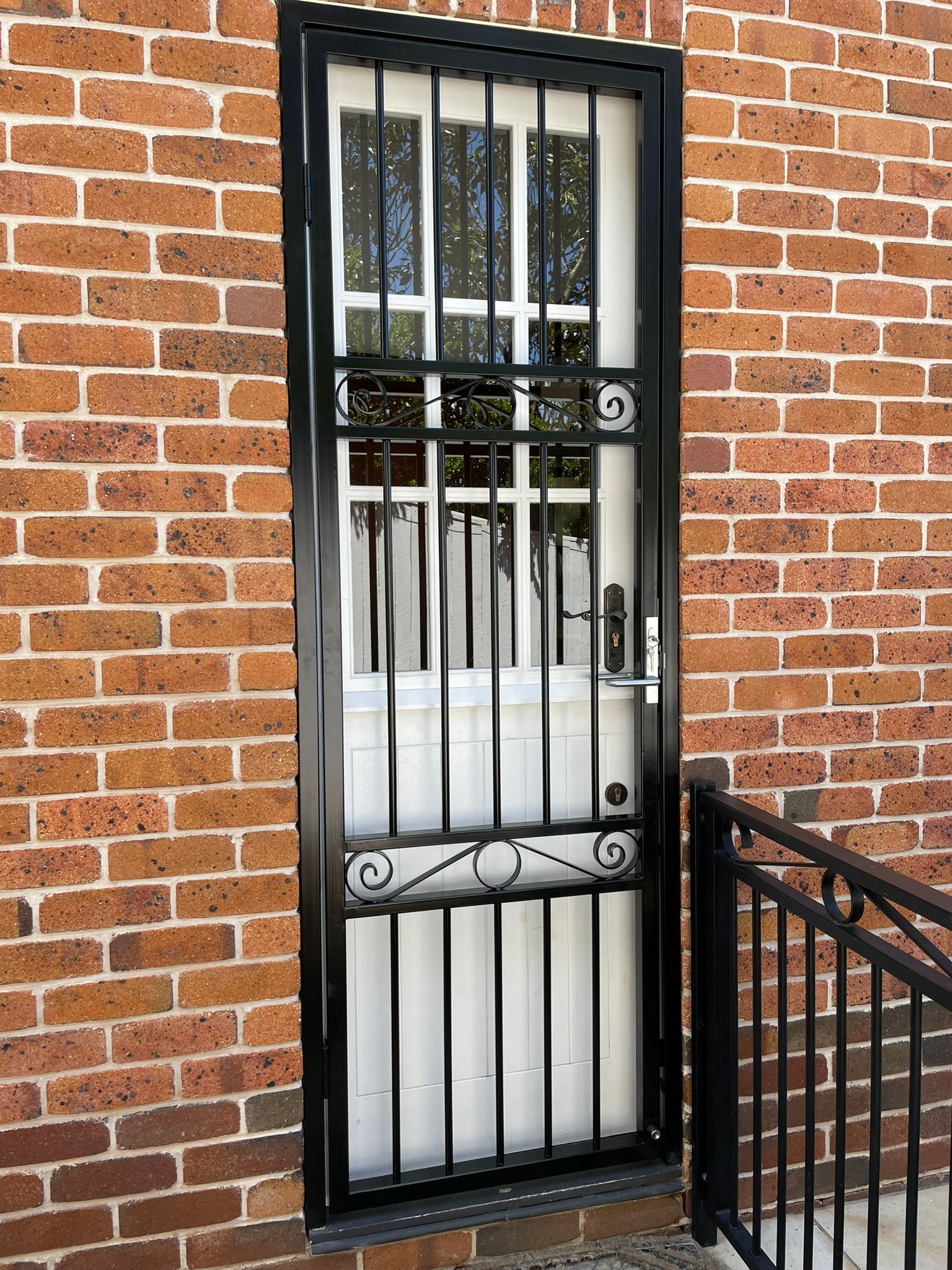 A balcony with a glass railing and a wooden railing