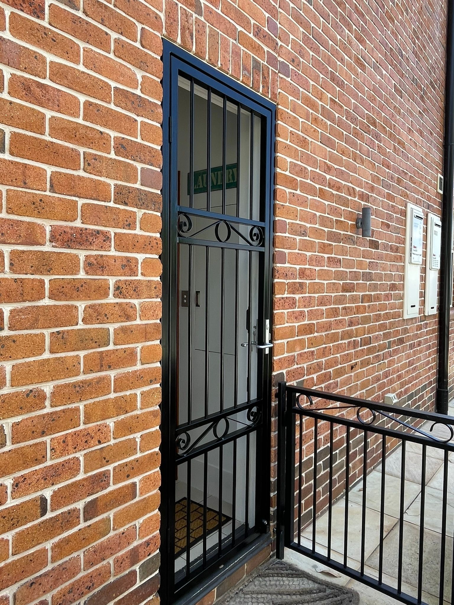 A close up of a wrought iron railing on a set of stairs
